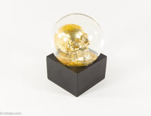 Load image into Gallery viewer, GLITTER/ BLING GOLD SKULL SNOWGLOBE ON BLACK WOOD BASE HALLOWEEN
