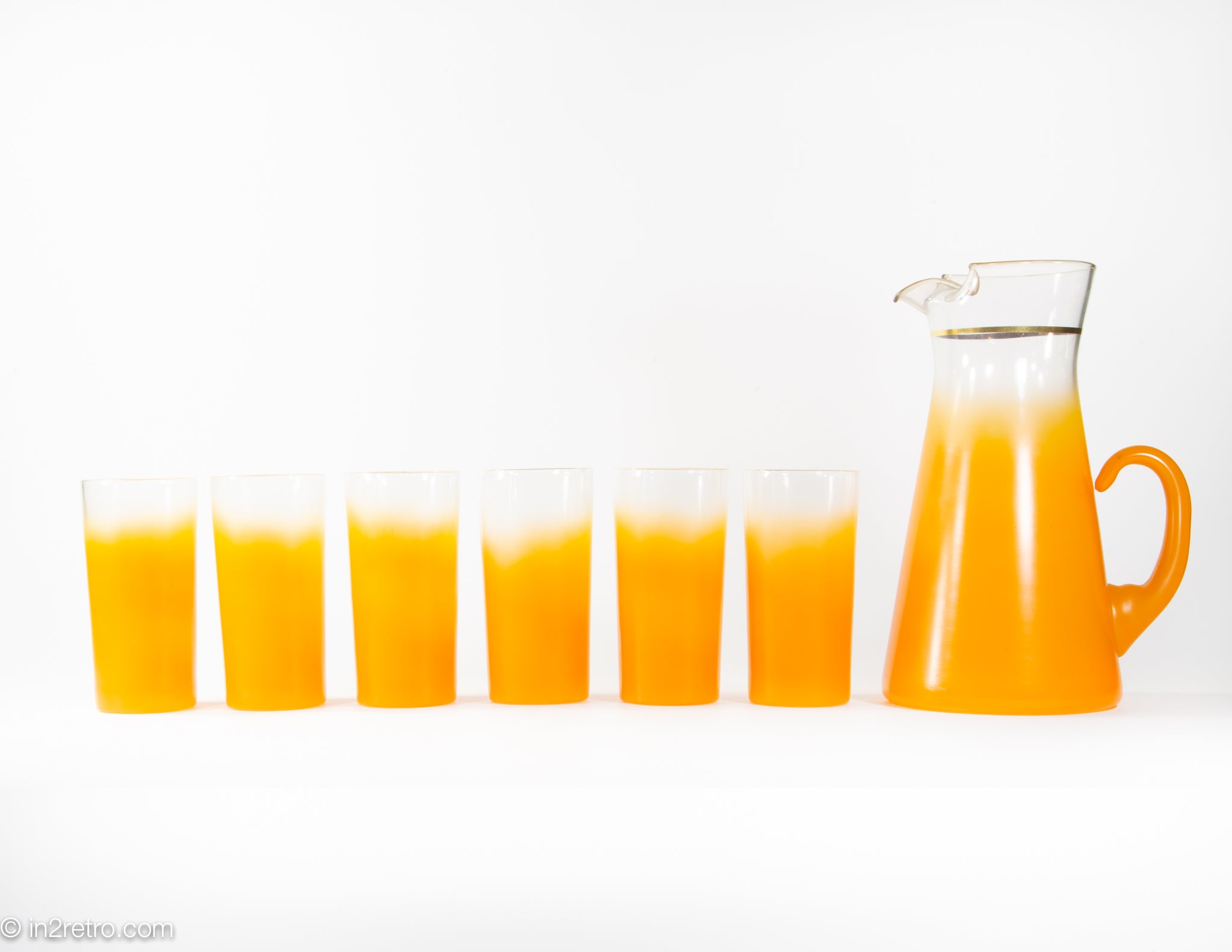 6 Anchor Hocking orange juice glasses with orange juice carafe in very good  condition